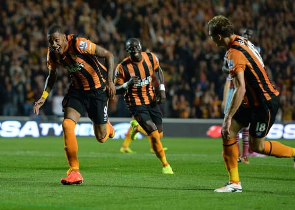 Hull City's Abel Hernandez, left, celebrates after scoring his side's first goal on Monday night against West Ham. Picture: PA.