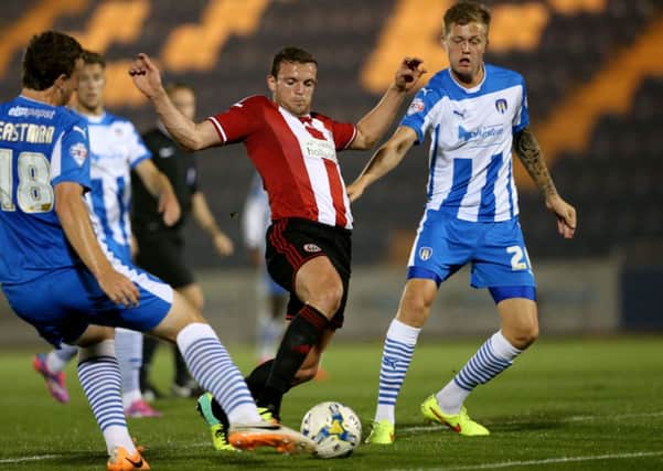 Sheffield United's James Wallace battles for possession against Colchester last night.
