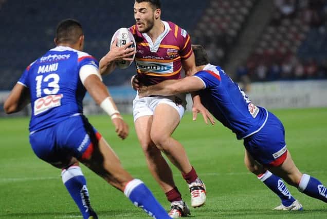Huddersfield's Jake Connor hits the Saints defence