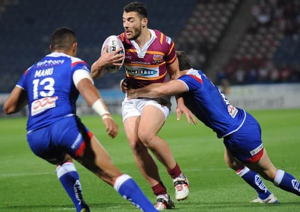 Huddersfield's Jake Connor hits the Saints defence