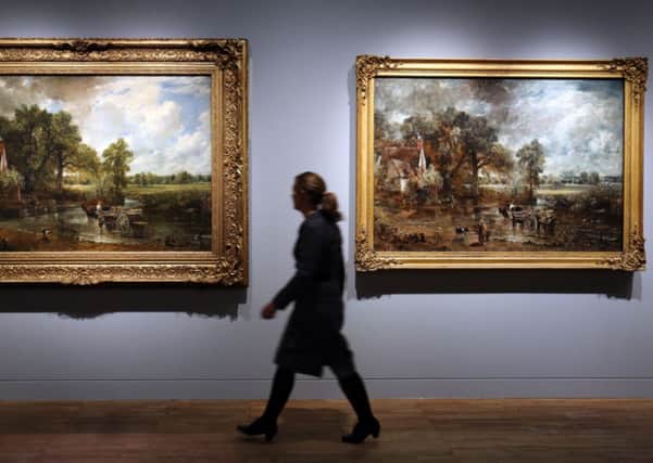 V&A museum employee Olivia Colling looks at John Constable's The Hay Wain at the opening of a new exhibition of his work