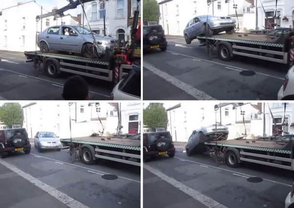 A driver taking his car off a lorry before it was taken away by council parking contractors