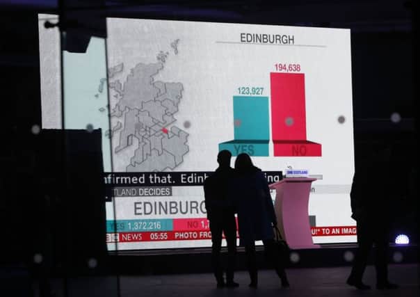 People view a large screen at Dynamic Earth in Edinburgh after Scotland rejected independence
