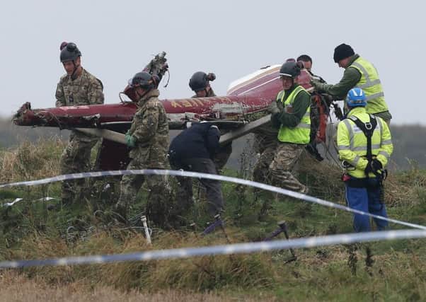 HM Coastguard and rescue workers recover the wreckage of an Agusta Bell 206 helicopter from steep cliffs at Selwick Bay, at Flamborough Head
