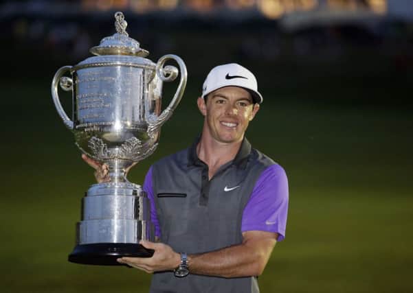 Rory McIlroy, of Northern Ireland, holds up the Wanamaker Trophy after winning the PGA Championship. He leads Europe's challenge at the Ryder Cup.