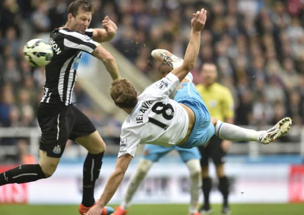 Hull's Nikica Jelavic scores during the Barclays Premier League match at St James' Park, Newcastle.