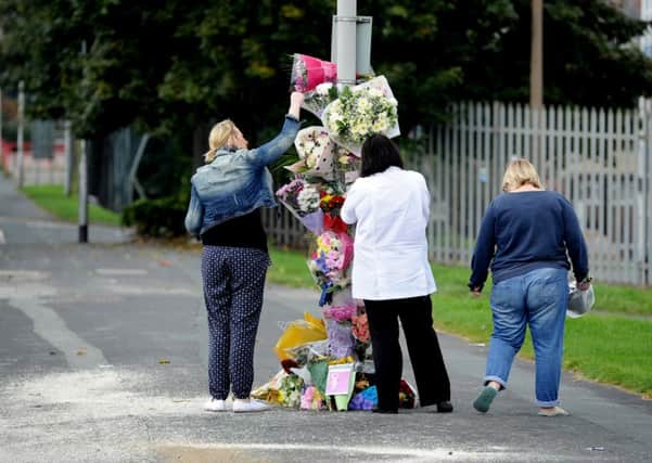 Flowers are laid at the scene of the crash Picture: James Hardisty