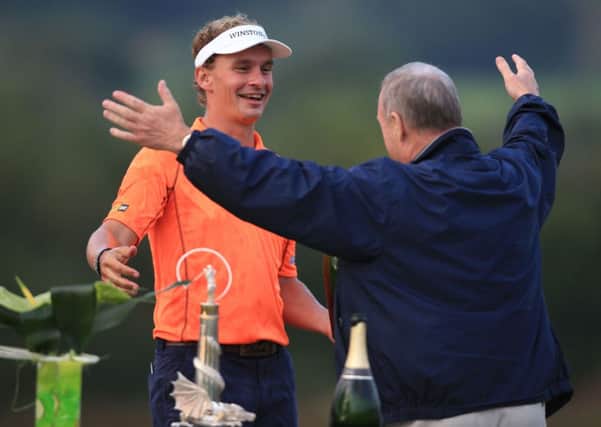 Netherlands' Joost Luiten, left, celebrates winning the Wales Open.