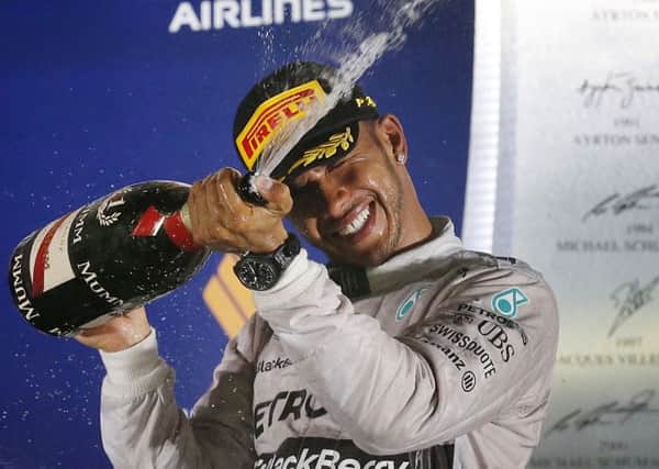 Mercedes' Lewis Hamilton celebrates after winning the Singapore Grand Prix.