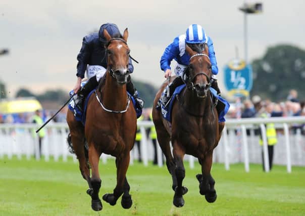 Tapestry, ridden by Ryan Moore, left, beats Taghrooda and Paul Hanagan to win this year's Darley Yorkshire Oaks.