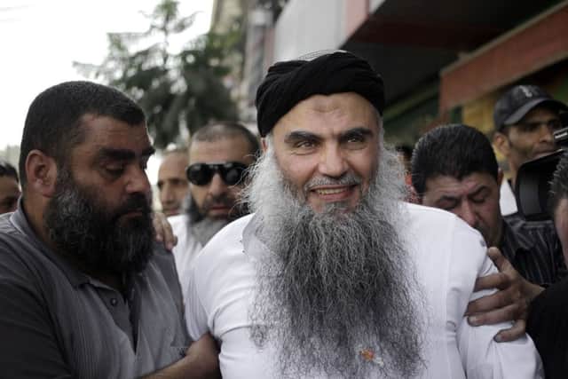 Family and friends of radical al-Qaida-linked preacher Abu Qatada greet him as he arrives to his family's home in Amman, Jordan
