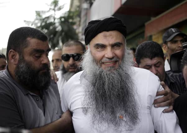 Family and friends of radical al-Qaida-linked preacher Abu Qatada greet him as he arrives to his family's home in Amman, Jordan