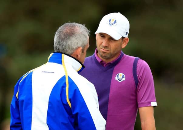 Europe's Sergio Garcia (right) listens to captain Paul McGinley