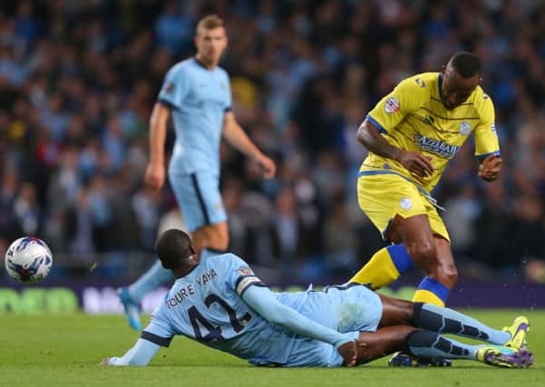 Sheffield Wednesday's Kamil Zayatte challenges Manchester City's Yaya Toure during the Capital One Cup Third Round match at the Etihad Stadium, Manchester.