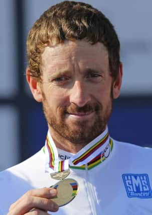 New world champion Britain's Bradley Wiggins shows his gold medal after winning the men's individual time trial event over 47.1 kilometers (29.3 miles) at the Road Cycling World Championships in Ponferrada, north-western Spain
