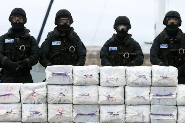 Members of the navy stand behind what is believed to be around 80 million euro of cocaine which was taken from onboard the yacht Makayabella