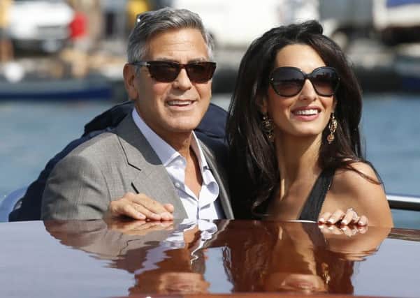 George Clooney, left, and Amal Alamuddin arriving in Venice, Italy, ahead of their wedding.  Pic: AP Photo/Luca Bruno