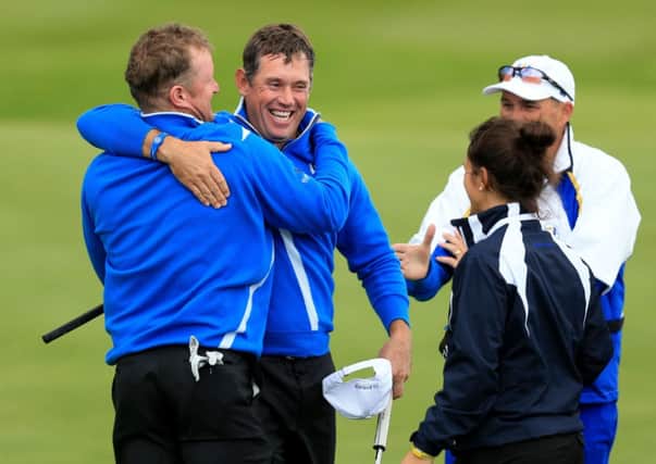 Europe's Jamie Donaldson, left, and Lee Westwood celebrate after winning there foursomes match.