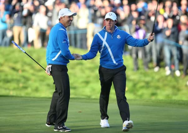 Europe's Rory McIlroy, right, and Sergio Garcia enjoy a high during the foursomes.