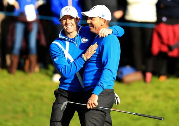 Europe's Sergio Garcia celebrates with playing partner Rory McIlroy on day one at Gleneagles.