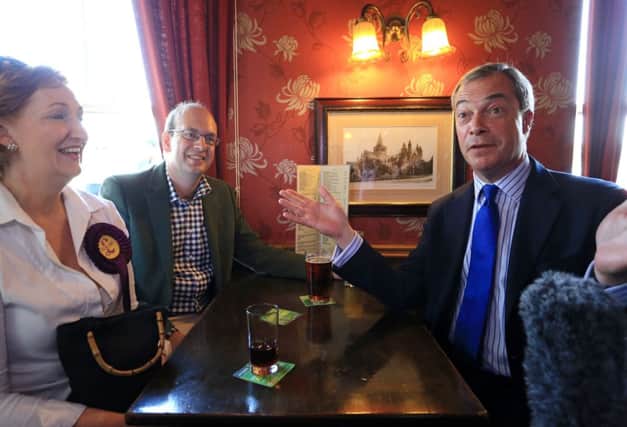 Tory defector Mark Reckless (second left) and Ukip leader Nigel Farage have a drink in the Crown Public House in Rochester.