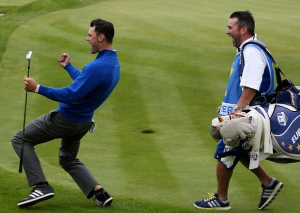 Europe's Martin Kaymer (left) celebrates winning his singles match on day three of the 40th Ryder Cup at Gleneagles Golf Course