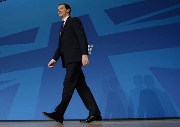 Chancellor George Osborne walks on stage to make his keynote address to the Conservative Party conference