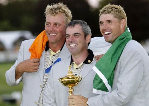 Darren Clarke, left, and Paul McGinley, centre, pictured with Padraig Harrington after playing their part in Europes win over the USA in the 2004 Ryder Cup at Oakland Hills (Picture: Morry Gash/AP).