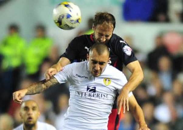 Leeds's Tommaso Bianchi is beaten in the air by Reading's Glenn Murray.