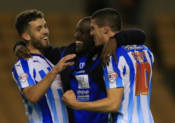Huddersfield Town manager Chris Powell celebrates with his players Tommy Smith and Conor Coady.