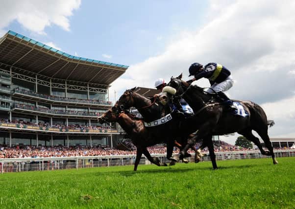 The Rectifier ridden by Micky Fenton (centre) beats Smarty Socks ridden by Daniel Tudhope (left) at York last year.