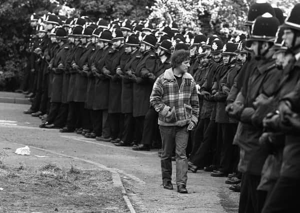 A picket inspecting a line of police officers outside the Orgreave coking plant near Rotherham.