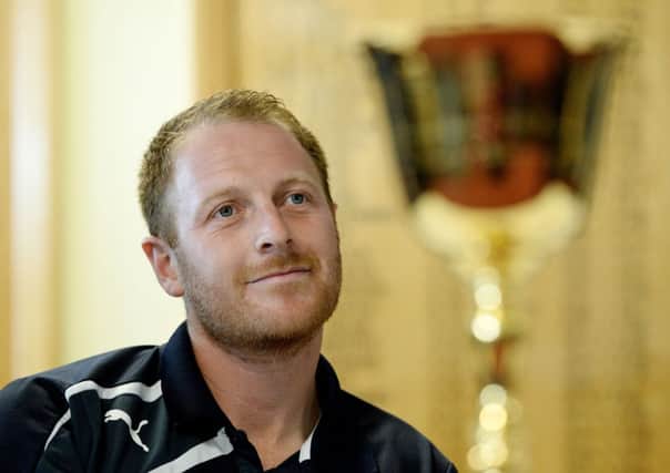 Yorkshire Cricket Club captain Andrew Gale sits next to the Championship trophy.