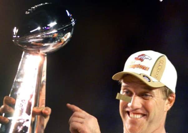 Denver Broncos quarterback John Elway points to the trophy following the Broncos' 34-19 victory over the Atlanta Falcons at Super Bowl XXXIII Sunday, Jan. 31, 1999 in Miami. (AP Photo/John Gaps III)