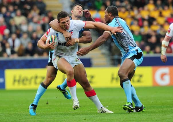England's Sam Burgess is tackled by Fiji's Daryl Millard