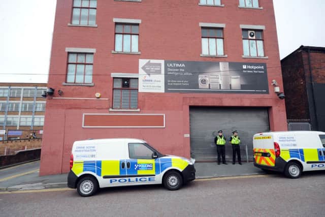 Police stand guard outside the cannabis factory