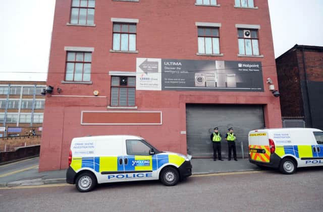 Police stand guard outside the cannabis factory