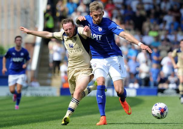 Aidy White is held off the ball by a strong challenge from Daniel Jones in the pre-season friendly against 
Chesterfield