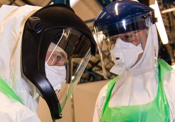 Doctors and nurses don protective equipment during training for Operation Gritrock at the training centre in Strensall, York