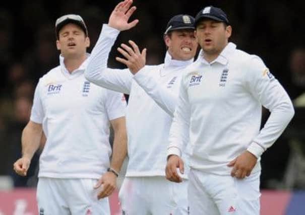 England's (left to right) Andrew Strauss, Graham Swann and Tim Bresnan react during the Investec International Test Match at Lords Cricket Ground, London.