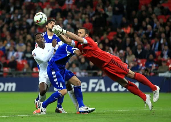 England's Danny Welbeck challenges for the ball with San Marino goalkeeper Aldo Simoncini at Wembley last night.