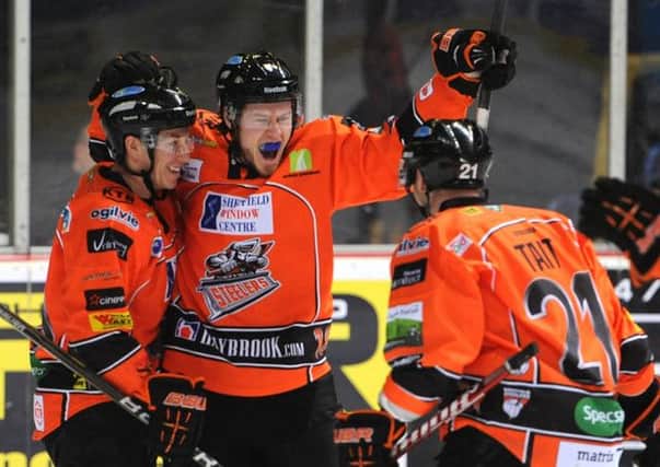 Steven Goertzen, centre, and Ashley Tait, right, celebrate a goal during their one season together at Sheffield Steelers. Picture: Dean Woolley.