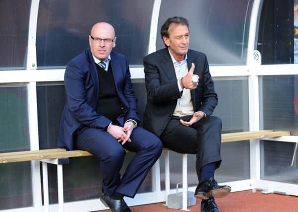 Massimo Cellino sits with Brian McDermott.