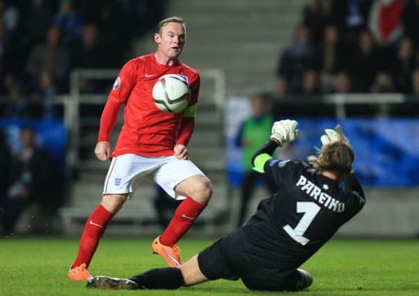 England's Wayne Rooney has a shot on goal.
