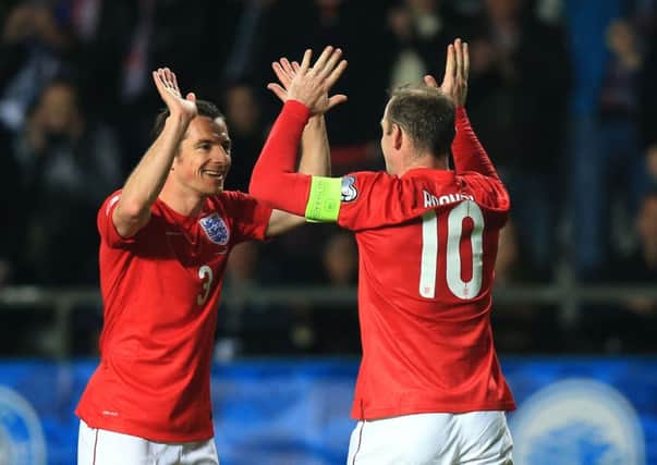 England's Wayne Rooney (right) celebrates scoring with team-mate Leighton Baines.