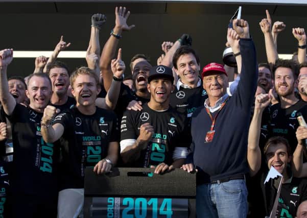 Mercedes driver Lewis Hamilton leads his team's celebrations.