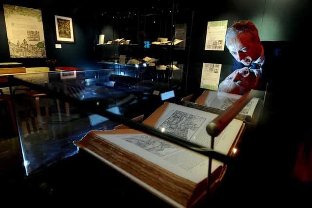 Roly Keating, Chief Executive of the British Library, looking at the first edition copy of the ancient mining manual De Re Metallica by Georgius Agricola written over 450 years ago.