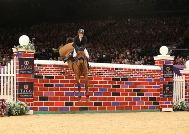UP AND OVER: Donald Whitaker rides Quick Laura AS Z on their way to a four-way tie in the prestigious Tagg Puissance.