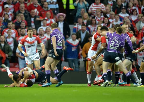 Wigan Warriors Ben Flower fights with St Helens Paul Wellens, far left, before being given a red card at Old Trafford.