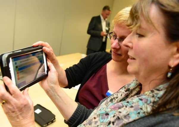 Ann Quinn, part of an advisory group, and Dr Esther Hobson try out a new app.